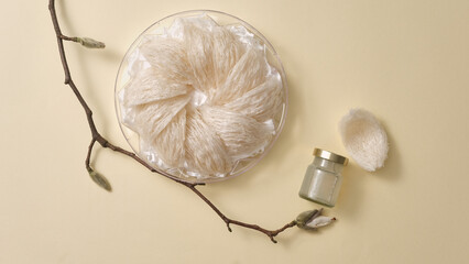 Bird's nest neatly arranged in tray, a bottle of unlabeled bird's nest water and flower branch on...