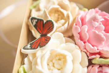 sweet dessert, gift, marshmallow peony flowers in a package, on a light background. Sugar addiction, consumption, handmade dessert. Low-calorie marshmallow, carbohydrates, decorative butterfly