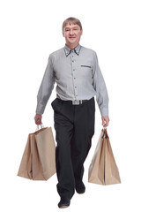 satisfied man with shopping bags striding forward.