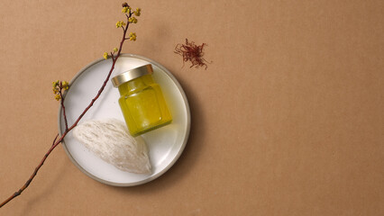 Bird’s nest raw on round dishes and saffron (Crocus sativus) on brown background. Mockup scene for product of bird's nest distilled with saffron - herbs good for health. Top view, flat lay