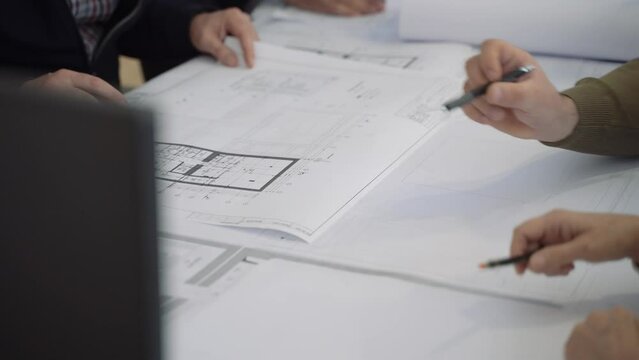 Architects collaborate on precise planning and creative problem-solving. Watch our team deliver innovative solutions with blueprints. Ideal for design and engineering projects.