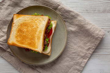 Homemade BLT Sandwich (Bacon, Lettuce and Tomato) on a Plate, top view. Flat lay, overhead, from above.