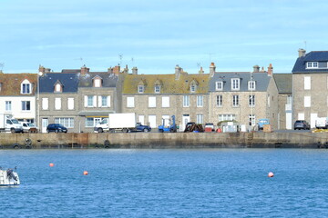 Barfleur, France - March 6th, 2023: A view of the harbor of Barfleur on a sunny day.
