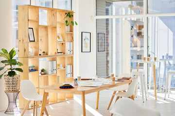 Empty interior office with light, wood furniture and workplace space for business and work. Modern and minimalist design decoration of a corporate or creative room for working employee or staff