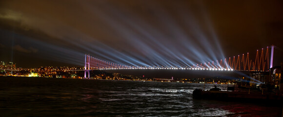 Istanbul Bosphorus Bridge and panoramic night view shot. Republic celebrations.. Bosphorus bridge Laser light show.