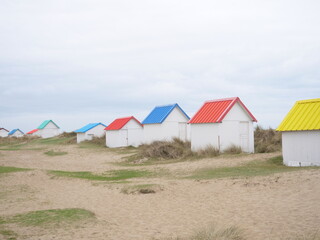 A view of the small beach cabins of Gouville-sur-Mer.