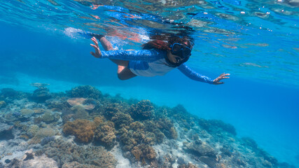 young lady learning how to snorkel in the great barrier reef