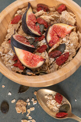 Granola for healthy breakfast. Bowl with granola , milk , fresh fig and dried berries