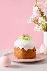 Easter homemade cake and painted eggs on pink background. Vertical format. Christian custom. Tasty traditional dessert. Orthodox Christianity.