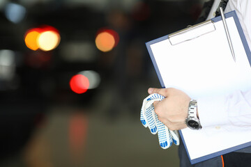 Auto mechanic and auto engineer technician holding clipboard blank sheet with copy space for car repair checklist