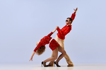 Disco ballroom dances. Expressive couple of dancers in bright retro fashion clothes, stage costumes...