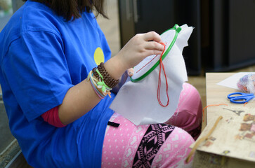 Tambour embroidery. Little girl hands embroidering with needle, thread and lace frame