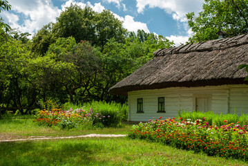 Fototapeta na wymiar Old ancient ukrainian village house with flowers, nature at summer time, Ukraine traditions and history