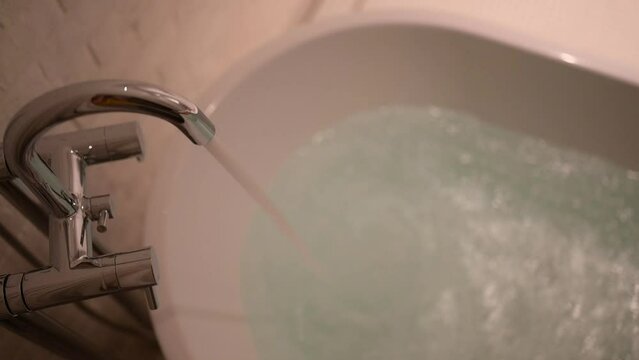 slow motion scene, water flowing in bathtub