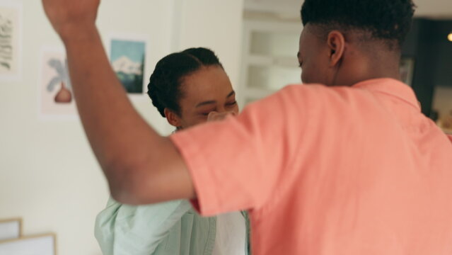 Excited Black Couple, Love And Dancing At Home For Love, Care And Funny Weekend Day Together. Happy, Smile And Laughing Black Woman, African Man And Crazy Young People Dance To Relax In Living Room