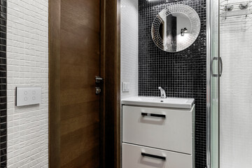 Bathroom with shower and large Jacuzzi bathtub with contrasting white and black walls
