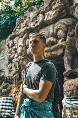 Young Man Exploring The Goa Gajah Temple In Bali, Indonesia