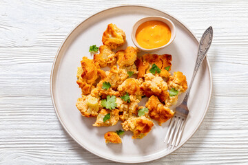 baked Cauliflower florets with sauce on plate