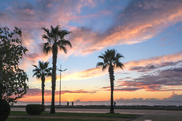 sunset ,sunrise on the beach. beautiful summer scenery. rocks on the sand. calm waves on the water....