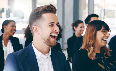 Obraz premium Light hearted moments keep everyones attention. Shot of a group of businesspeople laughing while attending a conference.