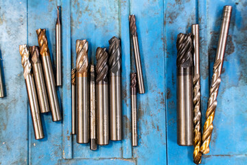 Used drill bits on the lathe rusty metal blue background