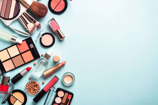 Make up cosmetic products on blue background. Flat lay image with copy space.