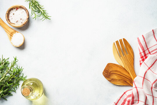 Kitchen Utensil With Herbs And Spices At Kitchen Table. Top View On White With Copy Space.