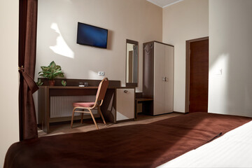 Clean white bath towels on the neatly clean bed of hotel room