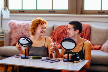 Young women applying makeup at home