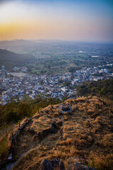 A town surrounded by some beautiful hills looking so beautiful as the sun goes down the western horizon!