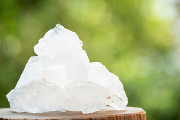 Alum crystal on nature bokeh background.