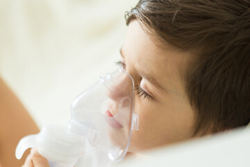 portrait of a boy doing inhalation