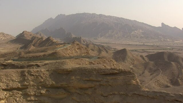 Aerial revealing shot of the stunning curvy roads at  Jabel Hafeet in Al Ain, UAE