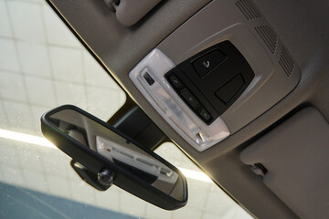 interior rear-view mirror of the car, SOS button and ceiling lights with power buttons on the ceiling