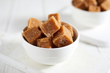 Close up brown cane sugar on white background