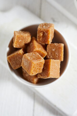 Close up brown cane sugar on white background
