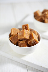 Close up brown cane sugar on white background