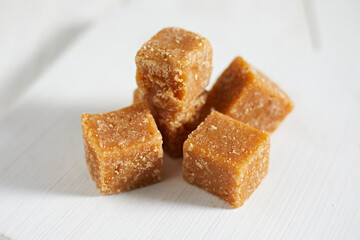 Close up brown cane sugar on white background