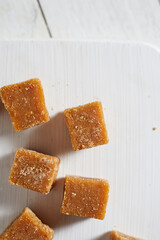 Close up brown cane sugar on white background