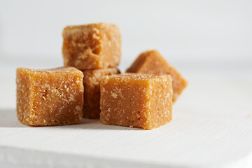 Close up brown cane sugar on white background