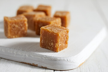 Close up brown cane sugar on white background