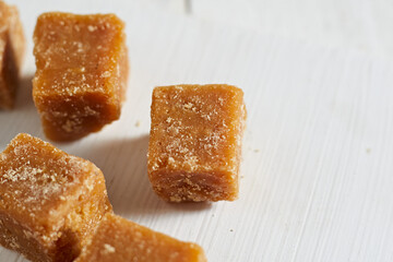 Close up brown cane sugar on white background