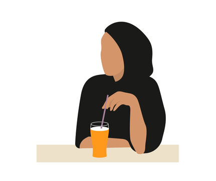 Muslim or arab woman sitting drinking orange juice