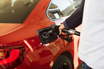 Man hand refuelling the car, Pumping gasoline fuel in car at petrol station. higher oil prices