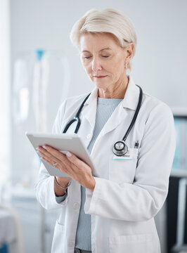Healthcare, research and senior doctor with tablet for online consulting, telehealth and wellness app. Cardiology, hospital and woman on digital tech for internet, medical results and patient data