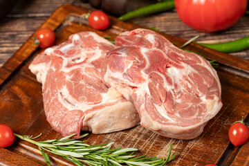 Lamb neck meat. Uncooked raw lamb neck on a wooden serving board