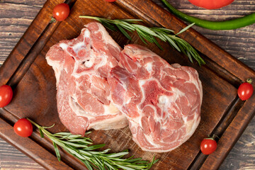 Lamb neck meat. Uncooked raw lamb neck on a wooden serving board. Top view