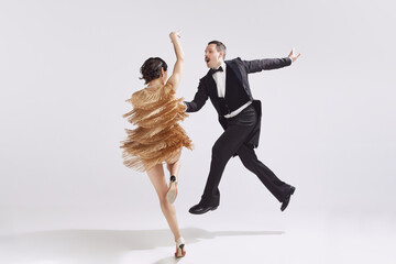 Passion. Elegant couple of dancers in vintage evening dress and suit dancing retro ballroom dance. Love and music, vintage fashion.