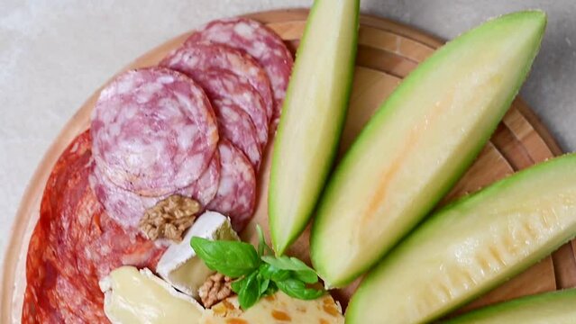 Charcuterie gourmet antipasti plater cheese, salami, prosciutto, melon board. 