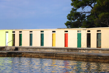 Colorful changing cabins, landmark on beach Jadrija, in Sibenik, Croatia.